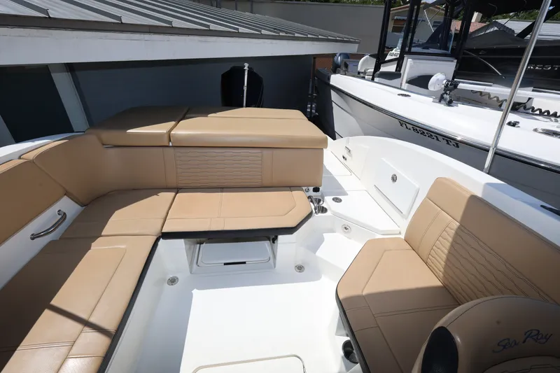 Slide: The Image of 2023 Sea Ray SPX 230 Outboard boat interior with tan seating and modern design. - 20