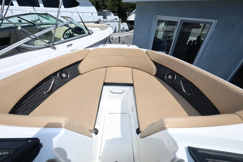 Slide: The Image of 2023 Sea Ray SPX 230 Outboard boat interior with tan seating and sleek design. - 16