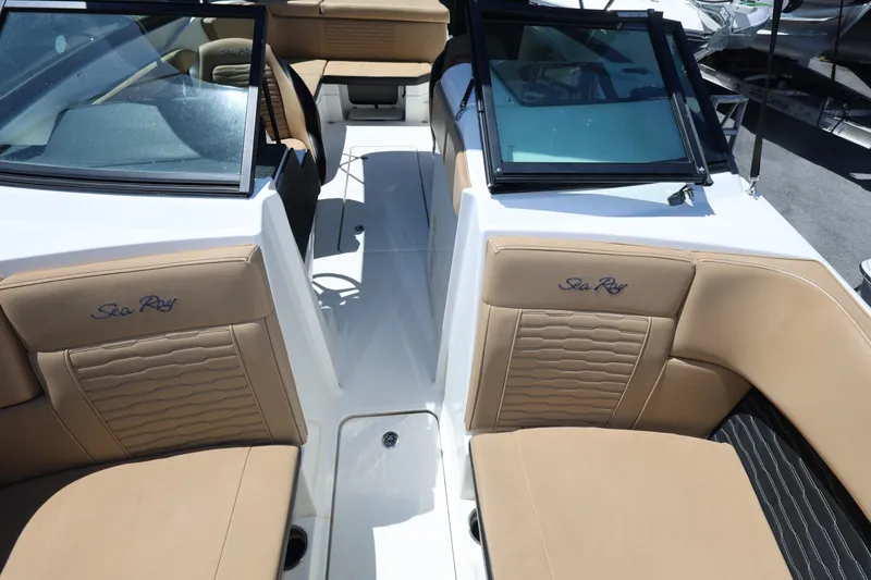Slide: The Image of 2023 Sea Ray SPX 230 Outboard boat interior with tan seating and windshield. - 17