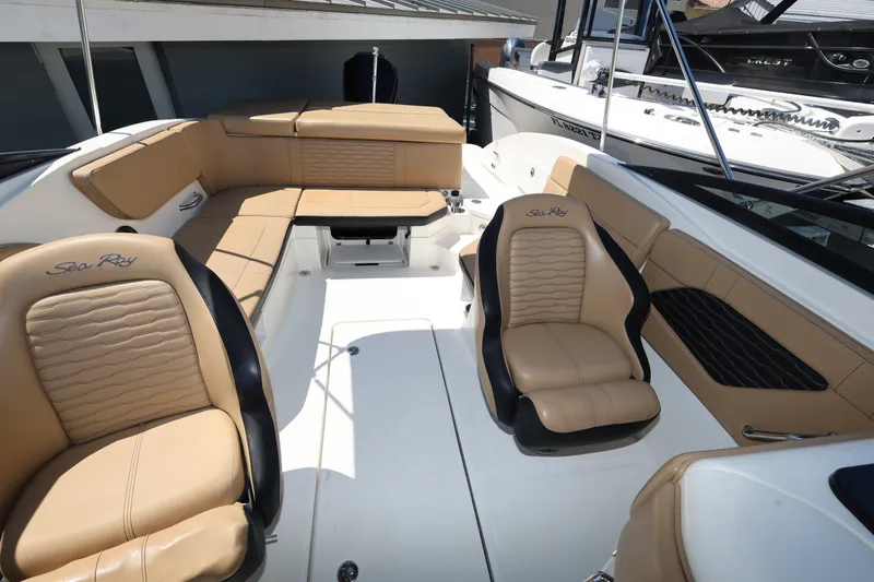 Slide: The Image of 2023 Sea Ray SPX 230 Outboard interior with tan leather seating and spacious layout. - 19