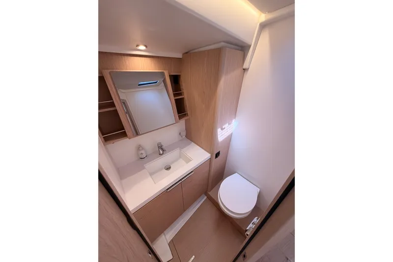 Slide: The Image of Modern bathroom interior on 2022 Beneteau Oceanis Yacht 54, featuring sleek sink and toilet. - 83