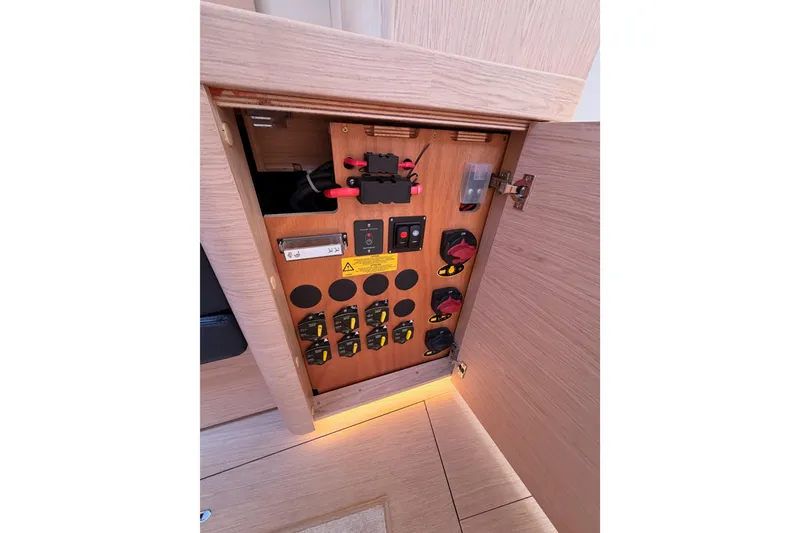Slide: The Image of Electrical panel inside 2022 Beneteau Oceanis Yacht 54, showcasing switches and wiring. - 70