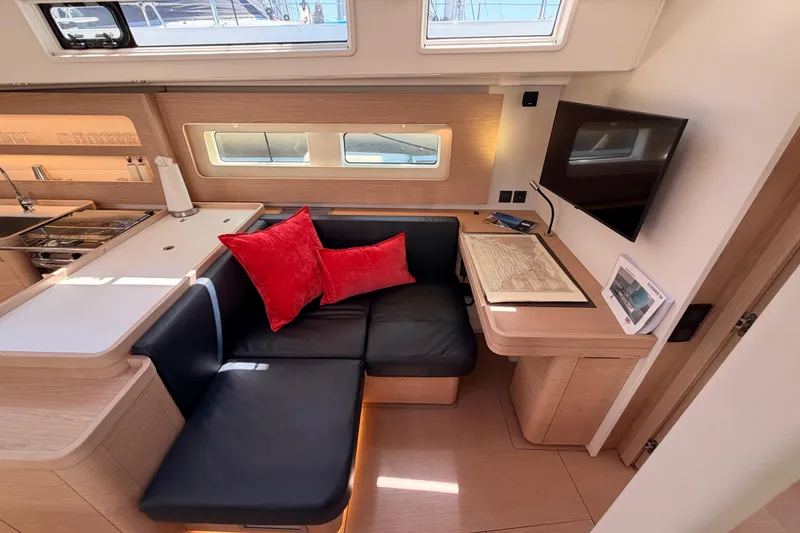 Slide: The Image of Luxurious interior of 2022 Beneteau Oceanis Yacht 54 with modern seating and navigation table. - 74