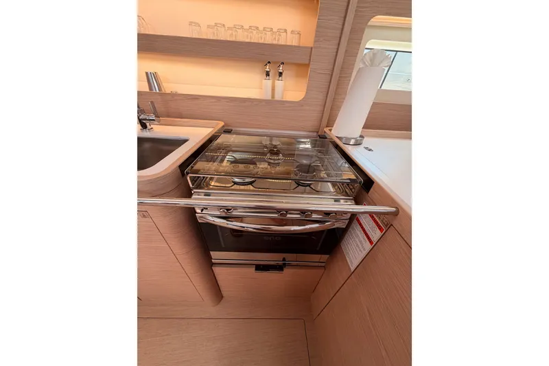 Slide: The Image of Modern kitchen in 2022 Beneteau Oceanis Yacht 54, featuring sleek appliances and elegant wood finish. - 50
