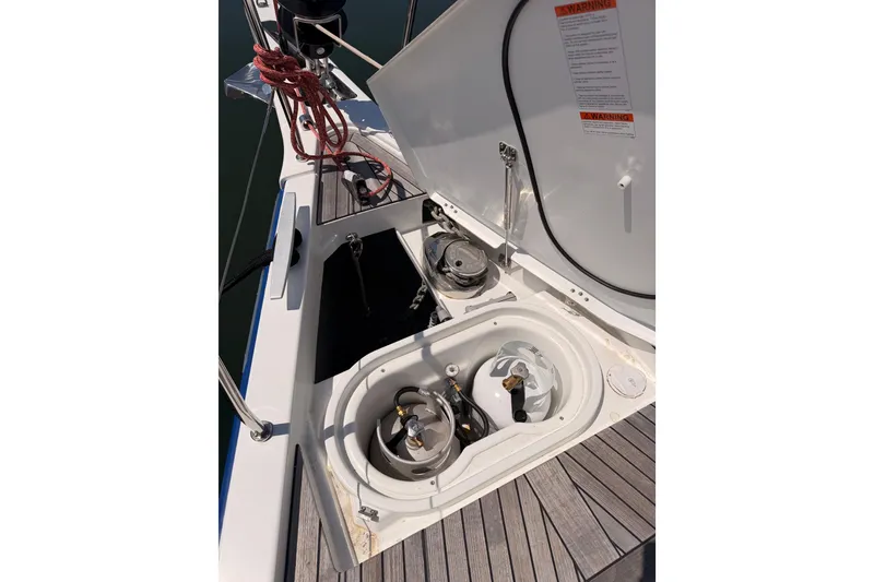 Slide: The Image of Beneteau Oceanis Yacht 54 (2022) deck with open storage compartments and equipment. - 22