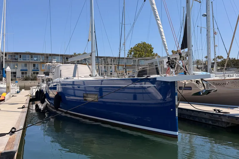 Slide: The Image of 2022 Beneteau Oceanis Yacht 54 docked at marina, blue hull, sunny day. - 95