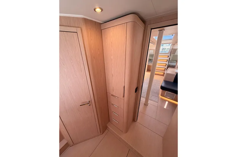 Slide: The Image of Interior of 2022 Beneteau Oceanis Yacht 54, featuring sleek wooden cabinetry and modern design. - 85