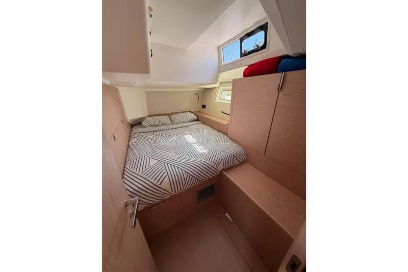Slide: The Image of Cozy cabin interior of 2022 Beneteau Oceanis Yacht 54 with modern bedding. - 55