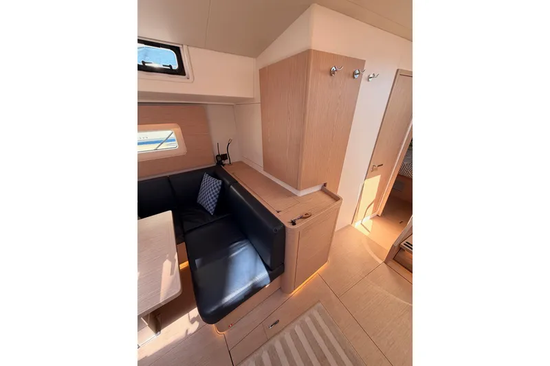 Slide: The Image of Interior of 2022 Beneteau Oceanis Yacht 54, featuring sleek wood finishes and comfortable seating. - 69