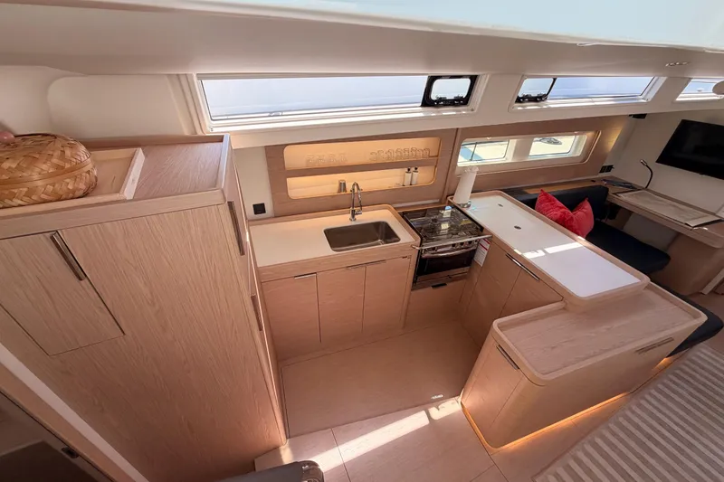 Slide: The Image of Modern kitchen interior of 2022 Beneteau Oceanis Yacht 54 with sleek wood finishes. - 45