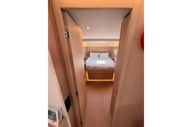 Slide: The Image of Luxurious cabin interior of 2022 Beneteau Oceanis Yacht 54, featuring a cozy bed and modern design. - 77