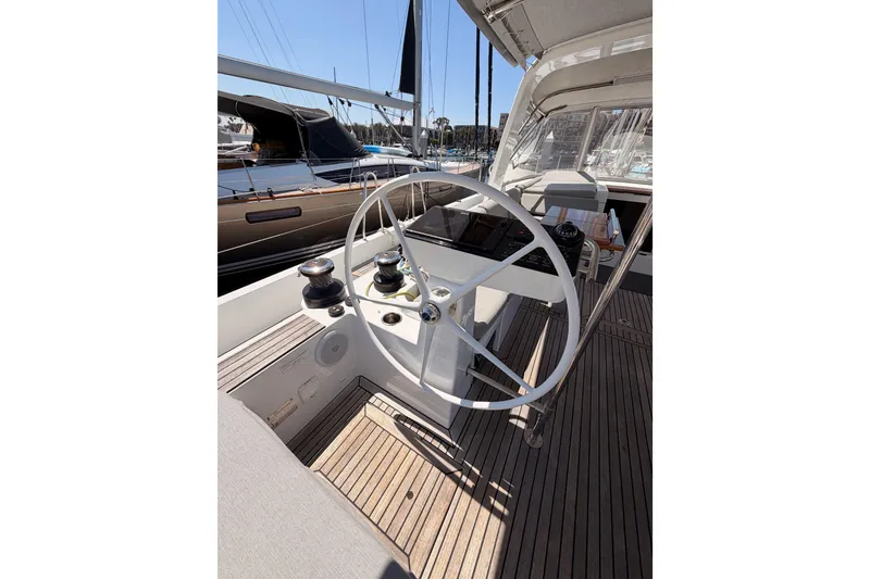 Slide: The Image of Steering wheel of 2022 Beneteau Oceanis Yacht 54, docked in a marina. - 34