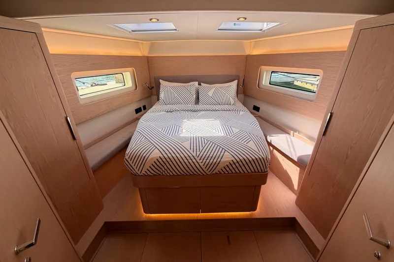 Slide: The Image of Luxurious cabin interior of 2022 Beneteau Oceanis Yacht 54 with modern bedding and natural light. - 79
