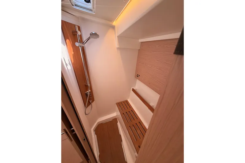 Slide: The Image of Shower area in 2022 Beneteau Oceanis Yacht 54, featuring wooden accents and modern fixtures. - 82