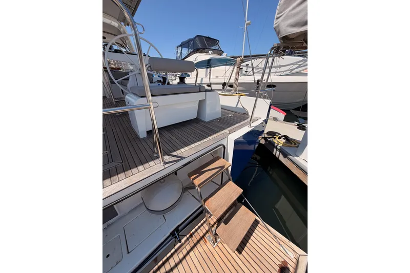 Slide: The Image of 2022 Beneteau Oceanis Yacht 54 with teak deck and elegant cockpit design. - 14
