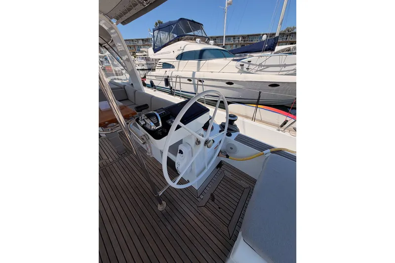 Slide: The Image of Cockpit of 2022 Beneteau Oceanis Yacht 54 with steering wheel and navigation controls. - 37