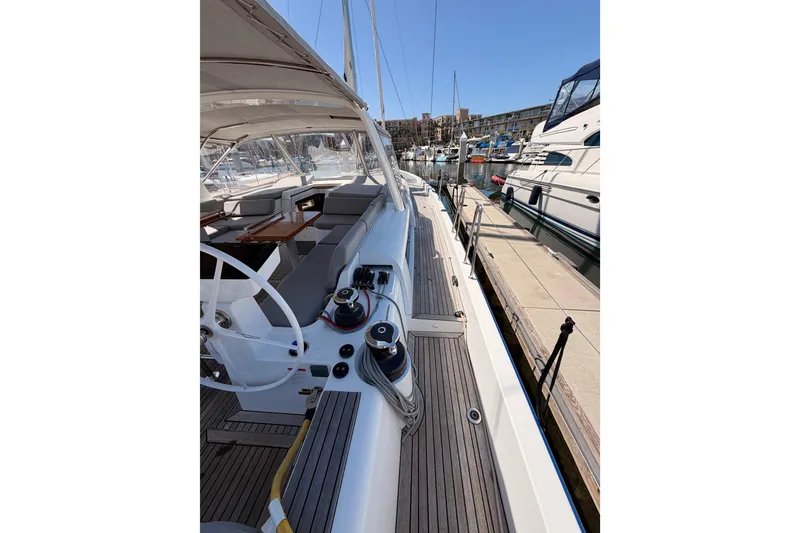 Slide: The Image of 2022 Beneteau Oceanis Yacht 54 docked, showcasing sleek deck and modern design. - 16