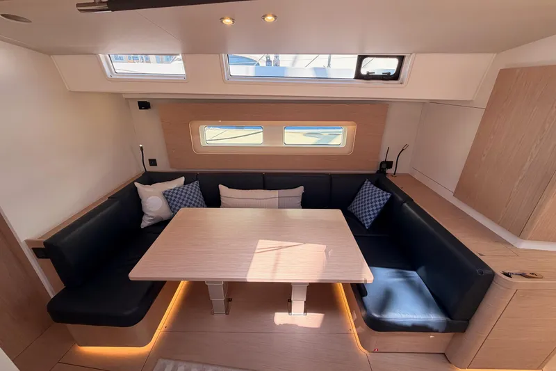Slide: The Image of Interior of 2022 Beneteau Oceanis Yacht 54 with modern seating and dining area. - 73
