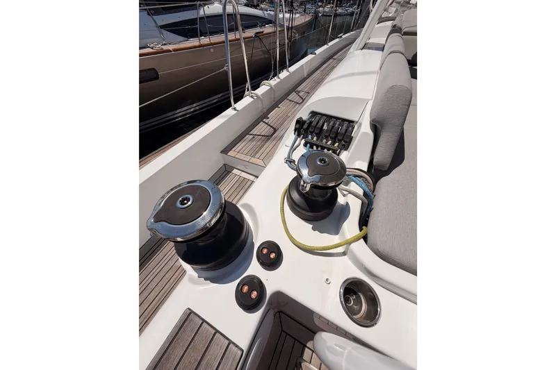 Slide: The Image of Deck view of 2022 Beneteau Oceanis Yacht 54, featuring winches and seating area. - 35