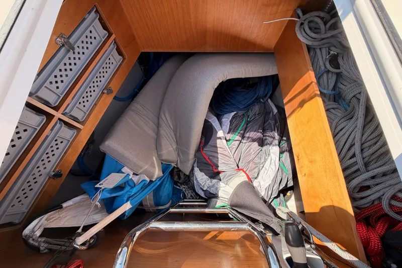 Slide: The Image of Storage compartment on a 2022 Beneteau Oceanis Yacht 54, filled with ropes and cushions. - 20
