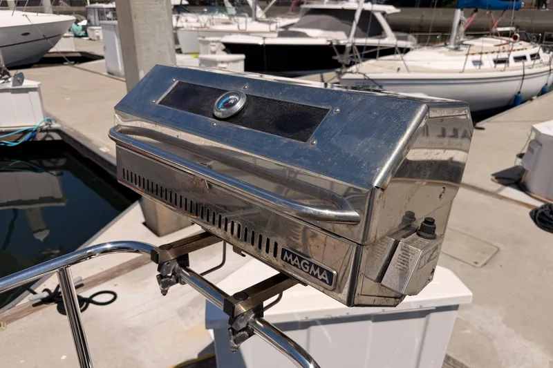 Slide: The Image of Stainless steel Magma grill on a 2022 Beneteau Oceanis Yacht 54 at a marina. - 92