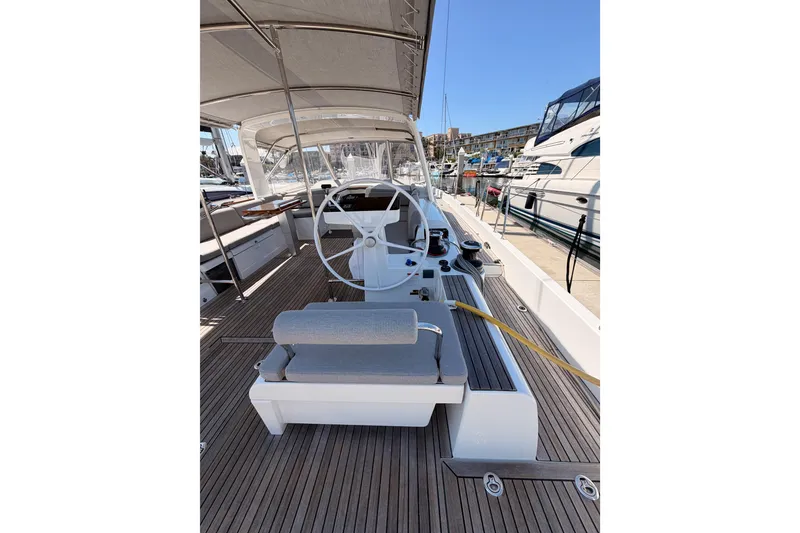 Slide: The Image of Cockpit of 2022 Beneteau Oceanis Yacht 54 with steering wheel and seating. - 15