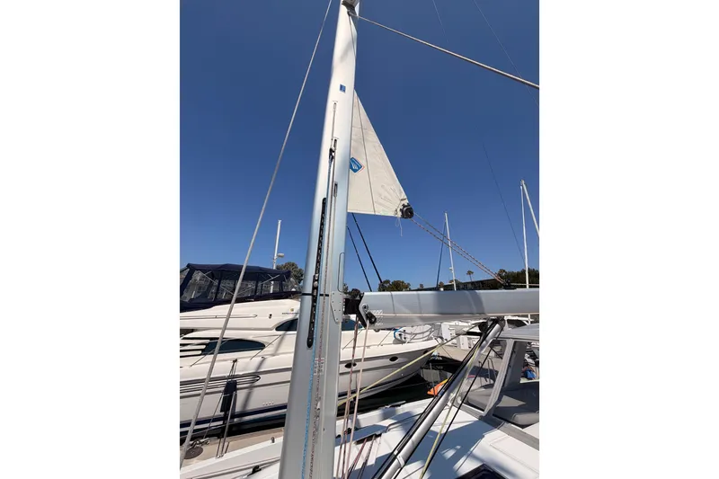 Slide: The Image of 2022 Beneteau Oceanis Yacht 54 mast and sail against clear blue sky. - 29