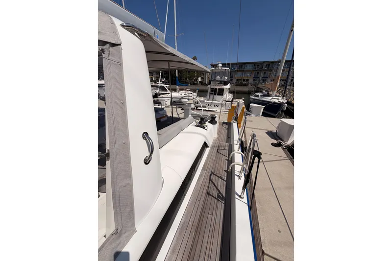 Slide: The Image of 2022 Beneteau Oceanis Yacht 54 docked at marina, showcasing sleek deck design. - 31
