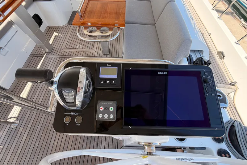 Slide: The Image of Control panel of 2022 Beneteau Oceanis Yacht 54 with navigation display and throttle. - 39