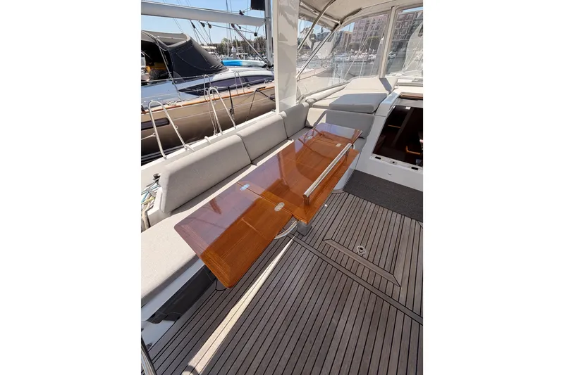 Slide: The Image of Luxurious 2022 Beneteau Oceanis Yacht 54 cockpit with elegant wooden table and comfortable seating. - 41
