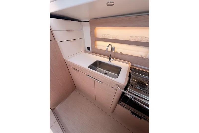 Slide: The Image of Modern kitchen interior of 2022 Beneteau Oceanis Yacht 54, featuring sleek cabinetry and stainless steel sink. - 51