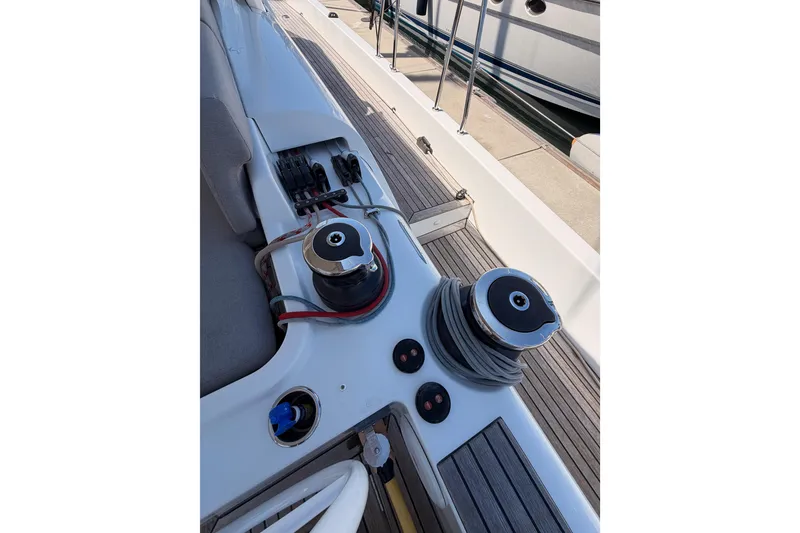 Slide: The Image of Deck view of 2022 Beneteau Oceanis Yacht 54, featuring winches and teak flooring. - 38