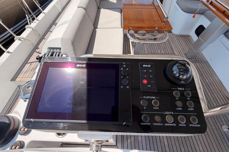 Slide: The Image of Control panel on 2022 Beneteau Oceanis Yacht 54 with navigation and seating area. - 36