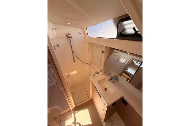 Slide: The Image of Luxurious bathroom in 2022 Beneteau Oceanis Yacht 54, featuring modern fixtures and ample natural light. - 63