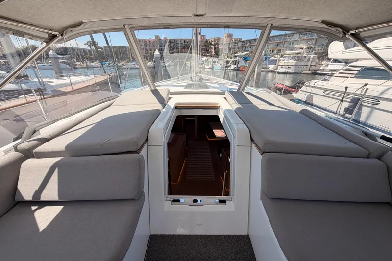 Slide: The Image of Luxurious 2022 Beneteau Oceanis Yacht 54 cockpit with comfortable seating and marina view. - 43