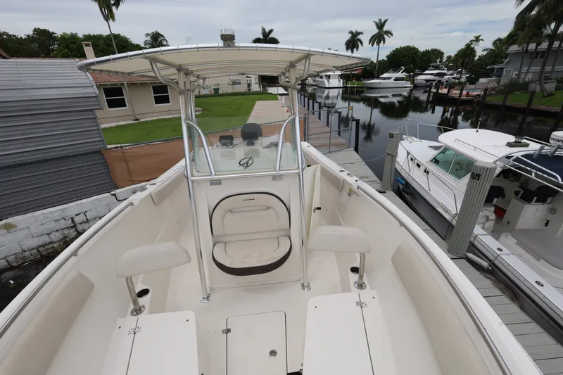 Slide: The Image of 2022 Sailfish 242 CC boat docked near waterfront homes and other boats. - 15
