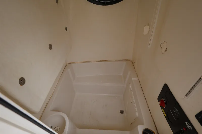 Slide: The Image of Interior view of 2022 Sailfish 242 CC boat compartment, featuring a clean, compact design. - 19