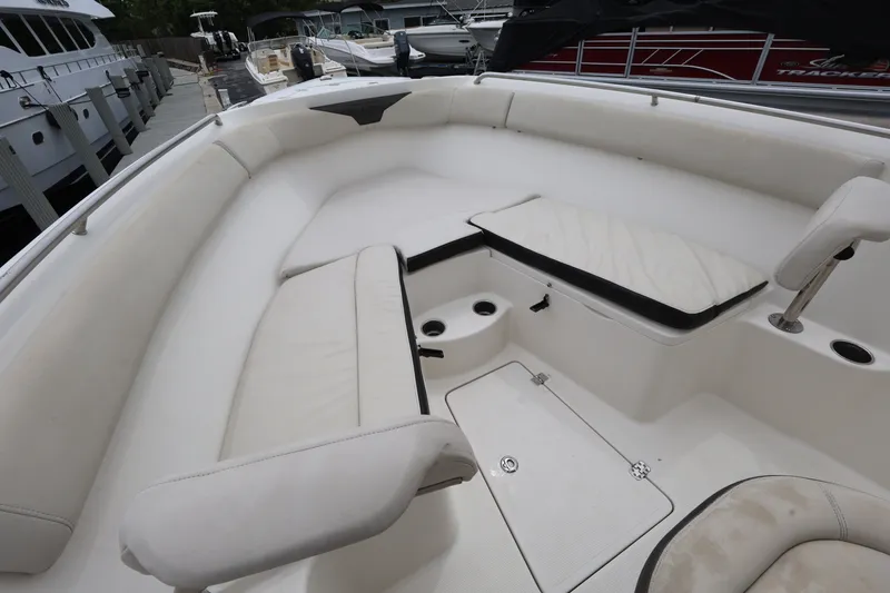 Slide: The Image of 2022 Sailfish 242 CC boat interior with cushioned seating and storage compartments. - 16