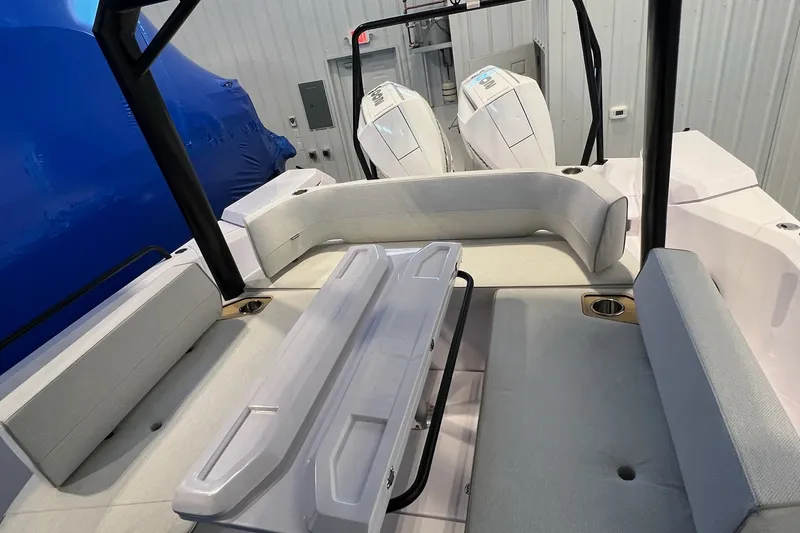 Slide: The Image of 2027 Axopar 29 Sun-Top boat interior with seating and dual engines. - 17