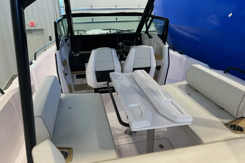 Slide: The Image of Interior view of a 2027 Axopar 29 Sun-Top boat with seating and table. - 23