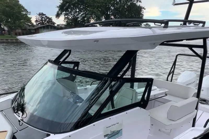 Slide: The Image of 2027 Axopar 29 Sun-Top boat with sleek design on a calm river. - 10