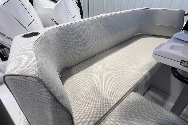 Slide: The Image of 2027 Axopar 29 Sun-Top boat interior with cushioned seating and cup holders. - 20