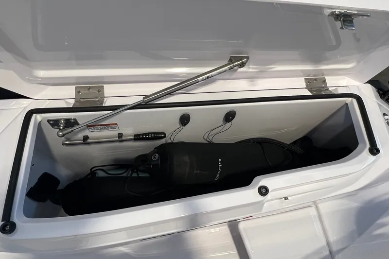 Slide: The Image of Open storage compartment on 2027 Axopar 29 Sun-Top boat, showing interior details. - 19