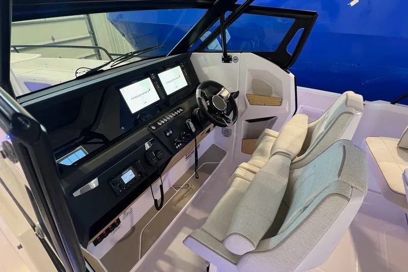 Slide: The Image of 2027 Axopar 29 Sun-Top boat interior with modern dashboard and comfortable seating. - 25