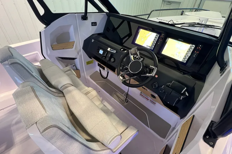 Slide: The Image of Interior view of 2027 Axopar 29 Sun-Top boat cockpit with dual navigation screens. - 26