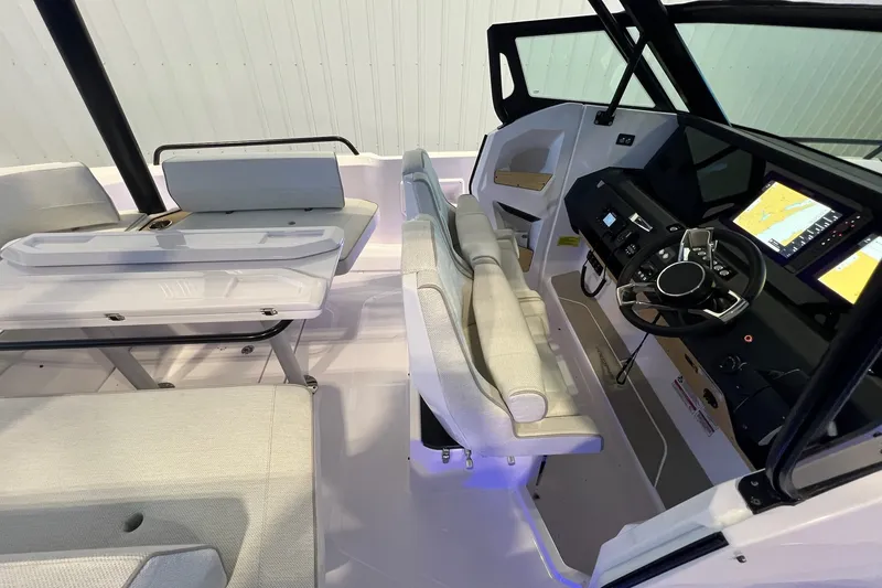 Slide: The Image of Interior view of 2027 Axopar 29 Sun-Top boat with modern helm and seating area. - 27