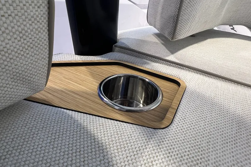 Slide: The Image of 2027 Axopar 29 Sun-Top boat interior with cup holder and textured upholstery. - 21
