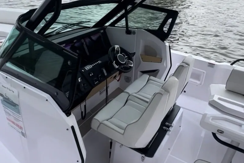 Slide: The Image of 2027 Axopar 29 Sun-Top boat interior with modern helm and seating. - 5