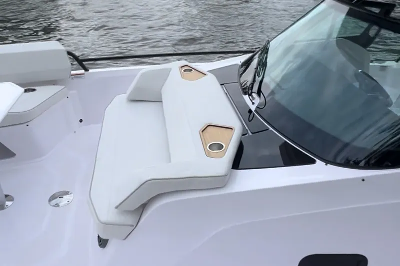 Slide: The Image of 2027 Axopar 29 Sun-Top boat with sleek seating and modern design on the water. - 9