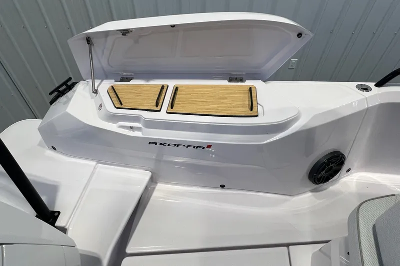 Slide: The Image of 2027 Axopar 29 Sun-Top boat with open storage compartment and sleek design. - 15